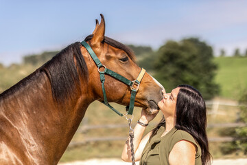 Young woman bonding with horse outdoors showing trust and affection