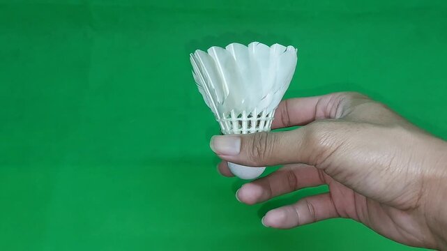 footage of an international standard badminton shuttlecock made from goose feathers, isolated on green screen. Perfect for sports videos, design projects, visual effects, and badminton-related content