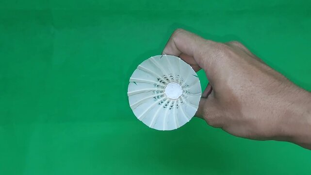 footage of an international standard badminton shuttlecock made from goose feathers, isolated on green screen. Perfect for sports videos, design projects, visual effects, and badminton-related content