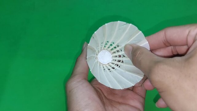 footage of an international standard badminton shuttlecock made from goose feathers, isolated on green screen. Perfect for sports videos, design projects, visual effects, and badminton-related content