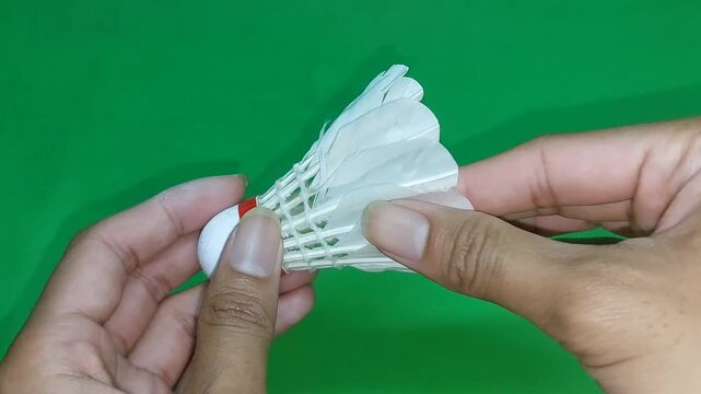 footage of an international standard badminton shuttlecock made from goose feathers, isolated on green screen. Perfect for sports videos, design projects, visual effects, and badminton-related content