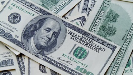 Macro Footage Of Many Crisp Us Hundred Dollar Bills Rotating On Tabletop. Concept Of Financial Wealth, Passive Income, Business Growth, And Abundance In Modern Capitalism. - Powered by Adobe