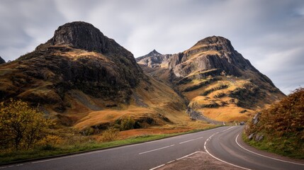 Winding road through autumnal Scottish mountains
