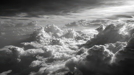 Obraz premium Clouds billow in dramatic formations above the earth during twilight hours