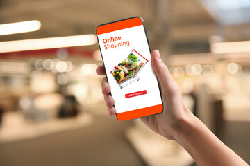 Food delivery. Man using mobile phone app to order grocery online, closeup