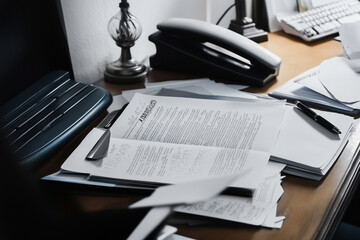 An executive's messy desk covered in paperwork, files, and a legal contract, illustrating the complexity of corporate business, finance, and decision-making