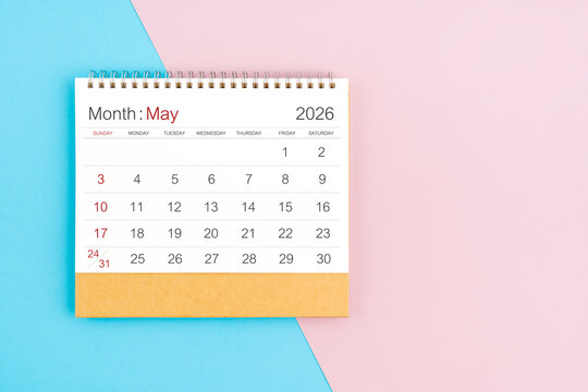 May 2026 desk calendar on blue and pink color background, with copy  space.