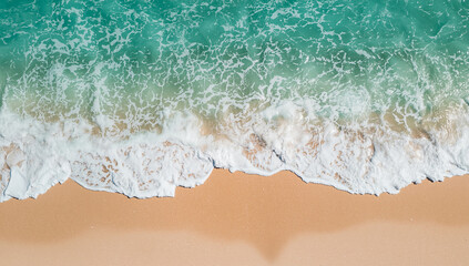 Aerial View of Ocean Waves Crashing on Sandy Beach with Turquoise Sea Water