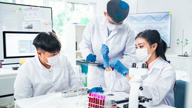 Diverse team of scientists, with a strong female presence, collaborating on blood testing in a modern laboratory, symbolizing teamwork, inclusion, empowerment, and healthcare innovation. - Powered by Adobe