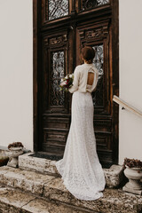 Bride with Bouquet in Front of Ornate Wooden Door