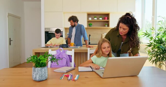 Family enjoying time together doing homework and homeschooling with computer 