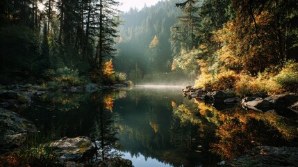 Tranquil autumn morning at a forest lake with mist rising and colorful foliage