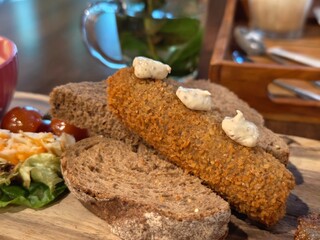Dutch herring with bread and salad on a wooden board for a delicious lunch meal