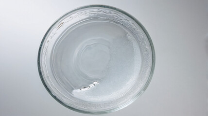 Overhead macro of a clear glass beaker with nutrient solution