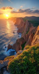 Fototapeta premium Dramatic coastal cliffs are lit by a setting sun, waves crash below as the sky blazes with warm colors