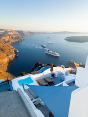 Fototapeta premium White architecture in Santorini island, Greece. Beautiful seascape at sunset.