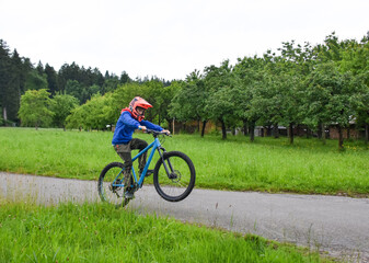 Boy doing a wheelie on a BMX bike outdoors in Switzerland