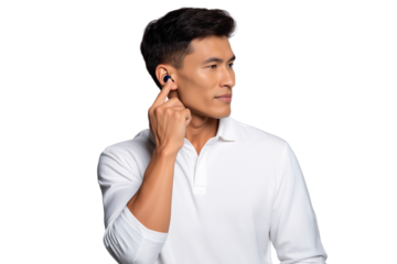 Handsome Asian man with a wireless earphone in his ear, pointing to the device, isolated on transparent background