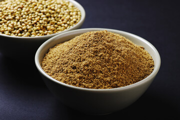 Indian food spices called coriander and coriander powder isolated on black background 