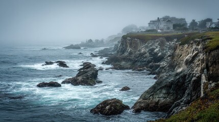 Obraz premium Misty coastal cliffs meet the ocean