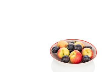 Juicy organic apples and black plums isolated on white background, macro.
