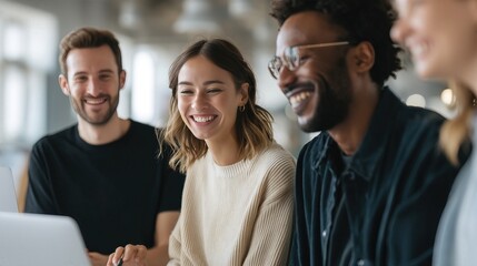 Obraz premium Shared Laughter and Teamwork: A group of diverse colleagues share a lighthearted moment, collaborating together in an office environment.