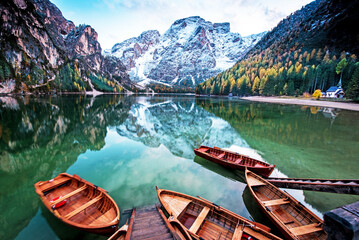 Magical autumn landscape with boats on the lake on Fanes-Sennes-Braies natural park in the Dolomites in South Tyrol, Alps, Italy.