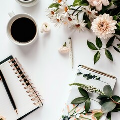 White workspace with coffee, flowers, and notebooks