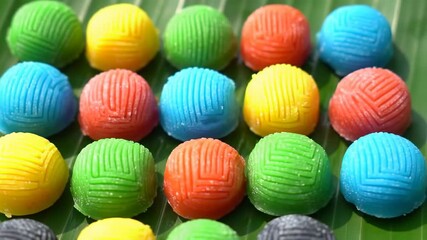 Colorful round treats on a vibrant green leaf, tasty sweet treat - Powered by Adobe