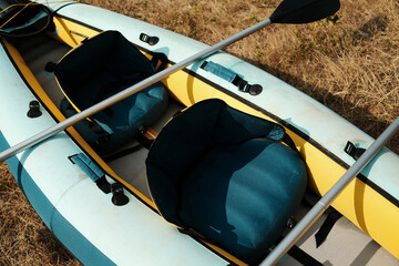 Close-up top view of inflatable kayak seats and paddles, water sports equipment detail