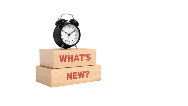 Alarm clock on wooden blocks with 'What's New?' message conveying freshness and innovation ideal