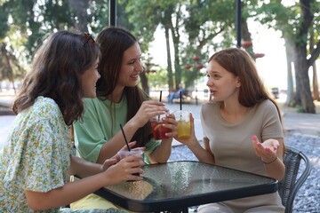 Friends enjoying refreshing drinks in outdoor cafe