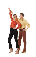 Fototapeta premium Happy couple in retro outfits dancing on white background
