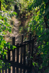 Old wooden gate in front of path leading into distance