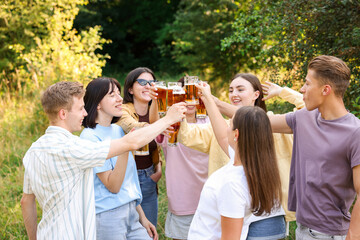 Group of happy friends clinking glasses of beer outdoors
