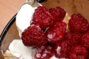Ripe raspberries and creamy bliss in a summer bowl