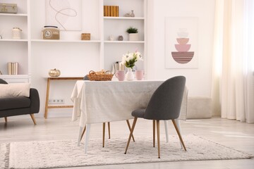 Stylish table with chairs and decor in dining room. Interior design