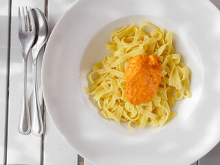 Plate of pasta with a sauce on top