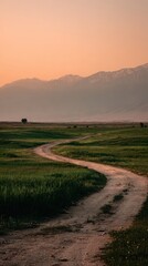 Obraz premium Winding Dirt Road Into Distance At Sunrise/Sunset