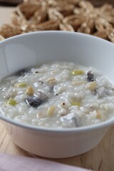 Mushroom chicken porridge, a nourishing Korean dish prepared with tender chicken and mushrooms by master chef Hanshunseop.