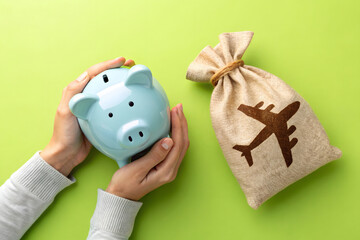 Piggy bank and a bag of airline tickets. The concept of saving on flights, accumulating bonuses and air miles. Discounts and promotions and great deals. Low-cost airlines  and reducing travel costs