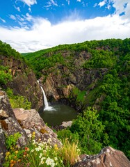 Waterfall cascading into a valley