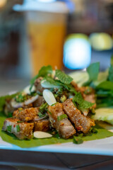 Spicy crispy pork salad or Larb. Thai food, served on plate.