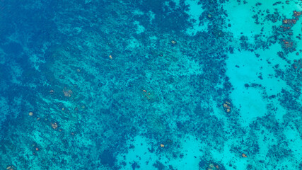 Stunning aerial view of the Surin Islands coastline with its lush green forests, coral reefs and deep blue waters filled with coral and a variety of fish, making it a popular destination for divers