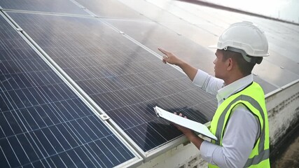 A solar panel maintenance worker is checking the performance of the solar panels - Powered by Adobe
