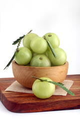 Fresh organic gooseberries in wooden bowl