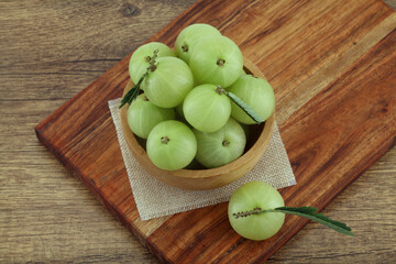  Fresh gooseberries in wooden bowl,Close up 
