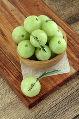 Fresh gooseberries in wooden bowl,Close up