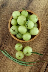  Fresh gooseberries in wooden bowl,Close up 