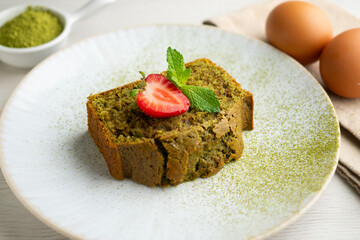 Japanese matcha tea cake decorated with strawberries. Traditional Japanese sweet cake recipe.